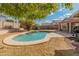 Relaxing kidney-shaped pool surrounded by a grassy backyard at 20967 N 96Th Ln, Peoria, AZ 85382