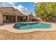 Inviting kidney-shaped pool with a large backyard at 20967 N 96Th Ln, Peoria, AZ 85382