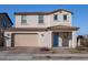 Two-story house with beige siding, a two-car garage, and landscaping at 21282 E Swan Dr, Queen Creek, AZ 85142