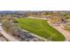 Aerial view of a community park with lush green grass, trees, and walking paths at 2227 W Calle Del Sol --, Phoenix, AZ 85085