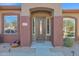 Front entry with a wood door and welcoming mat at 2227 W Calle Del Sol --, Phoenix, AZ 85085