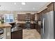 Kitchen with dark wood cabinets, granite counters, and stainless steel appliances at 2227 W Calle Del Sol --, Phoenix, AZ 85085