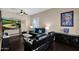 Living room with dark leather furniture and large-screen TV at 2227 W Calle Del Sol --, Phoenix, AZ 85085