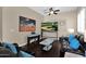 Living room with dark leather furniture and large-screen TV at 2227 W Calle Del Sol --, Phoenix, AZ 85085