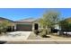 Single-story home with a two-car garage and desert landscaping at 24646 N Barley Rd, Florence, AZ 85132