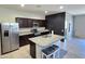 Modern kitchen with dark cabinets, granite countertops, and an island at 24646 N Barley Rd, Florence, AZ 85132