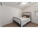 Cozy bedroom with a metal bed frame and window at 2485 S Quaintance St, Gilbert, AZ 85295