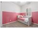 Small bedroom with daybed and pink wall at 2485 S Quaintance St, Gilbert, AZ 85295