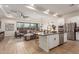 Open concept kitchen with island, stainless steel appliances, and white cabinets at 2485 S Quaintance St, Gilbert, AZ 85295