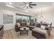 Living room with L-shaped sectional sofa and view of backyard at 2485 S Quaintance St, Gilbert, AZ 85295