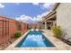 Relaxing pool area with spacious deck and brick wall at 2485 S Quaintance St, Gilbert, AZ 85295