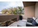 Relaxing balcony with seating area and treetop views at 25150 N Windy Walk Dr # 11, Scottsdale, AZ 85255