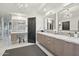 Modern bathroom with double vanity and large mirrors at 25150 N Windy Walk Dr # 11, Scottsdale, AZ 85255