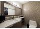 Modern bathroom features decorative tile wall, sleek countertops, and fixtures at 25150 N Windy Walk Dr # 11, Scottsdale, AZ 85255