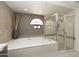 Bright and airy bathroom featuring a soaking tub and glass shower at 25150 N Windy Walk Dr # 11, Scottsdale, AZ 85255