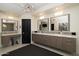 Modern bathroom featuring double vanity, sleek cabinetry, mosaic tile accents and a stylish lighting fixture at 25150 N Windy Walk Dr # 11, Scottsdale, AZ 85255