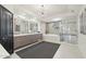 Bathroom featuring dual sinks, soaking tub, tiled shower, and modern fixtures at 25150 N Windy Walk Dr # 11, Scottsdale, AZ 85255