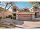 Two-story townhome with attached garage and landscaped walkway at 25150 N Windy Walk Dr # 11, Scottsdale, AZ 85255