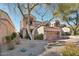 Two-story home with a tan facade and landscaped yard at 25150 N Windy Walk Dr # 11, Scottsdale, AZ 85255