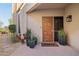 Inviting front entrance with a wooden door and potted plants at 25150 N Windy Walk Dr # 11, Scottsdale, AZ 85255