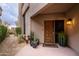 Inviting entryway with a wooden door and well-maintained landscaping at 25150 N Windy Walk Dr # 11, Scottsdale, AZ 85255