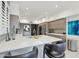 Contemporary kitchen featuring sleek cabinetry and breakfast bar at 25150 N Windy Walk Dr # 11, Scottsdale, AZ 85255