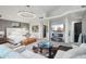 Bright main bedroom featuring modern lighting, fireplace, gray accent walls and luxurious sitting area at 25150 N Windy Walk Dr # 11, Scottsdale, AZ 85255