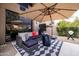 Cozy patio with sectional sofa, fire pit, and stylish patterned rug at 25150 N Windy Walk Dr # 11, Scottsdale, AZ 85255