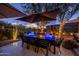 Evening patio scene with seating and umbrellas at 25150 N Windy Walk Dr # 11, Scottsdale, AZ 85255