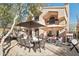 Spacious backyard patio with seating area, umbrella, and built-in grill at 25150 N Windy Walk Dr # 11, Scottsdale, AZ 85255