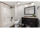 Bathroom with tub, toilet and dark vanity with granite top at 2524 S El Paradiso -- # 121, Mesa, AZ 85202