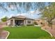 Spacious backyard with covered patio and lush landscaping at 27573 N 174Th Dr, Surprise, AZ 85387