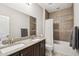 Bathroom boasts double sinks, granite counters, and a shower/tub combo at 27573 N 174Th Dr, Surprise, AZ 85387