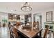 Bright dining room featuring a wood table and kitchen view at 27573 N 174Th Dr, Surprise, AZ 85387