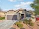 Single-story home with brown garage door and landscaping at 27573 N 174Th Dr, Surprise, AZ 85387