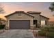 Front view of a single-story house with a two-car garage at 27573 N 174Th Dr, Surprise, AZ 85387