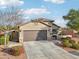 Single-story home with brown garage door and landscaping at 27573 N 174Th Dr, Surprise, AZ 85387