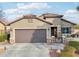 Single-story home with brown garage door and landscaping at 27573 N 174Th Dr, Surprise, AZ 85387