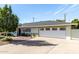 Charming single-story home with a well-manicured lawn, mature tree, and a two car garage at 2808 N Granite Reef Rd, Scottsdale, AZ 85257