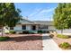 Charming single-story home featuring mature trees, a walkway, and a well-manicured front yard at 2808 N Granite Reef Rd, Scottsdale, AZ 85257