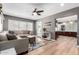 Comfortable living room with a large window, hardwood floors, sectional sofa, and views into the kitchen at 2808 N Granite Reef Rd, Scottsdale, AZ 85257