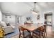 Open-concept living room featuring a dining area, comfortable sofa, modern decor, and hardwood floors at 2808 N Granite Reef Rd, Scottsdale, AZ 85257