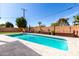 Inviting backyard pool with a tiled deck, landscaped planter boxes, and clear blue skies at 2808 N Granite Reef Rd, Scottsdale, AZ 85257