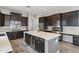 Modern kitchen with dark wood cabinets and an island at 2822 E Clifton Ct, Gilbert, AZ 85295