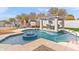 Resort-style backyard with a glistening pool, spa, and waterfall feature at 2822 E Clifton Ct, Gilbert, AZ 85295