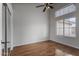 Bedroom with ceiling fan, natural light from the large windows, and wood floors at 2830 S Arroyo Ct, Chandler, AZ 85286