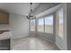 Dining area featuring modern chandelier, large windows, and tile flooring at 2830 S Arroyo Ct, Chandler, AZ 85286