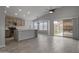 Open kitchen with pendant lighting, island, stainless appliances and sliding glass door to backyard at 2830 S Arroyo Ct, Chandler, AZ 85286