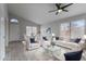 Bright living room featuring stylish furniture, vaulted ceilings, large windows, and a view of the dining area at 2830 S Arroyo Ct, Chandler, AZ 85286