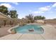 A backyard pool features rock waterfalls, desert landscaping, and a flagstone patio at 2830 S Arroyo Ct, Chandler, AZ 85286